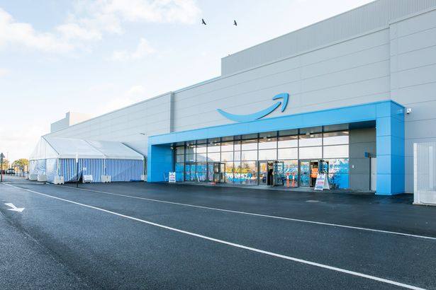 The entrance of Amazon's fulfilment centre in Swindon, with the Amazon logo above the glass frontage