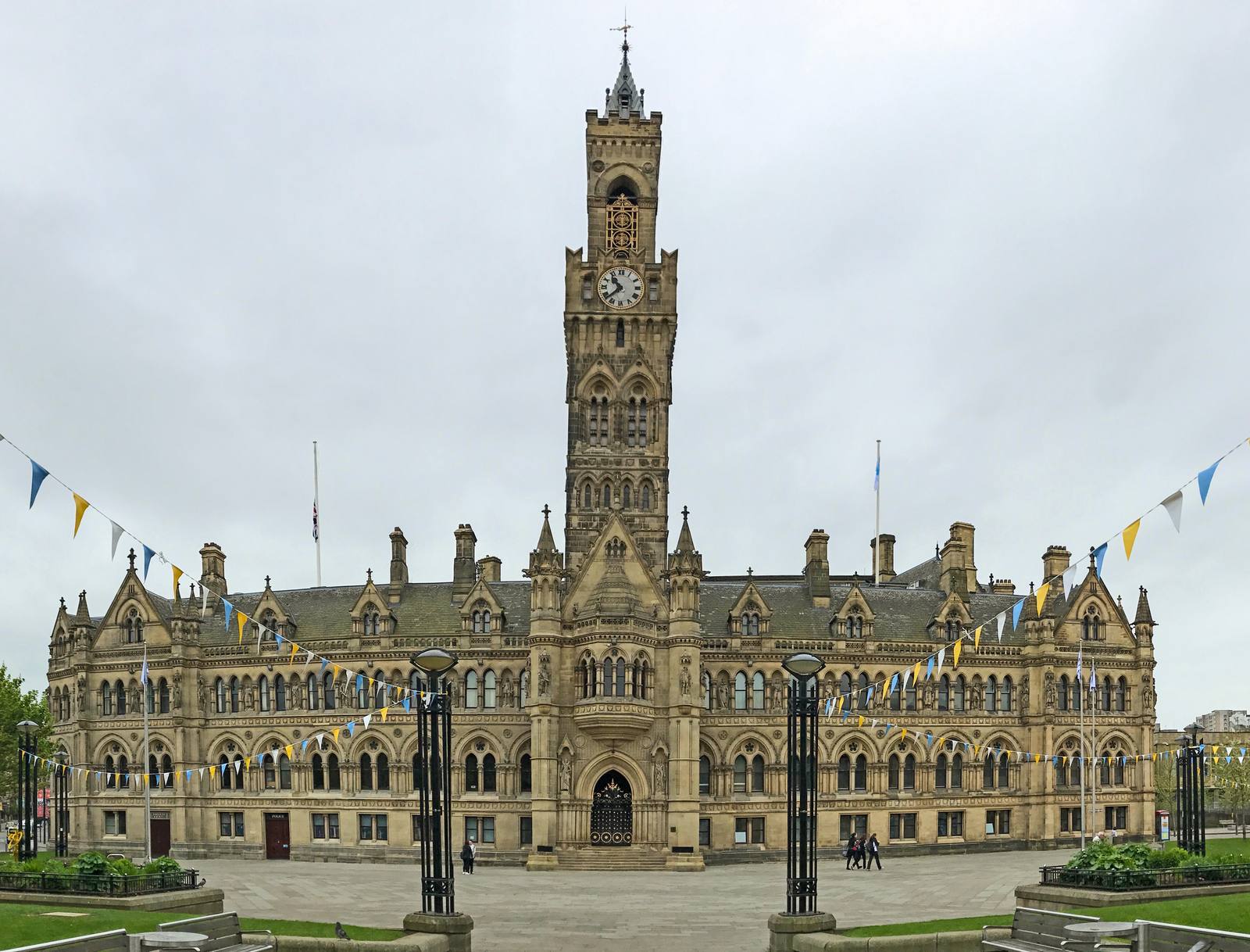 Bradford City Hall and its clock tower seen across Centenary Square, with bunting strung across the square