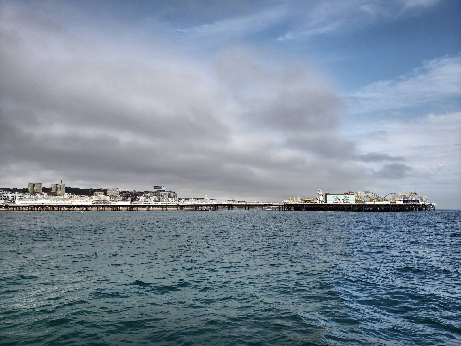 Brighton Palace Pier seen from the sea, with the city seafront behind