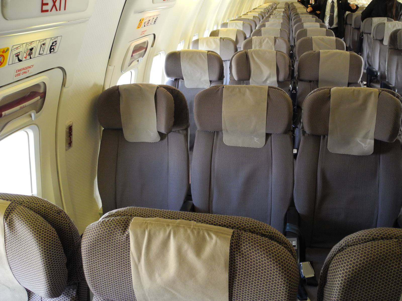 Rows of economy seats in an airliner cabin