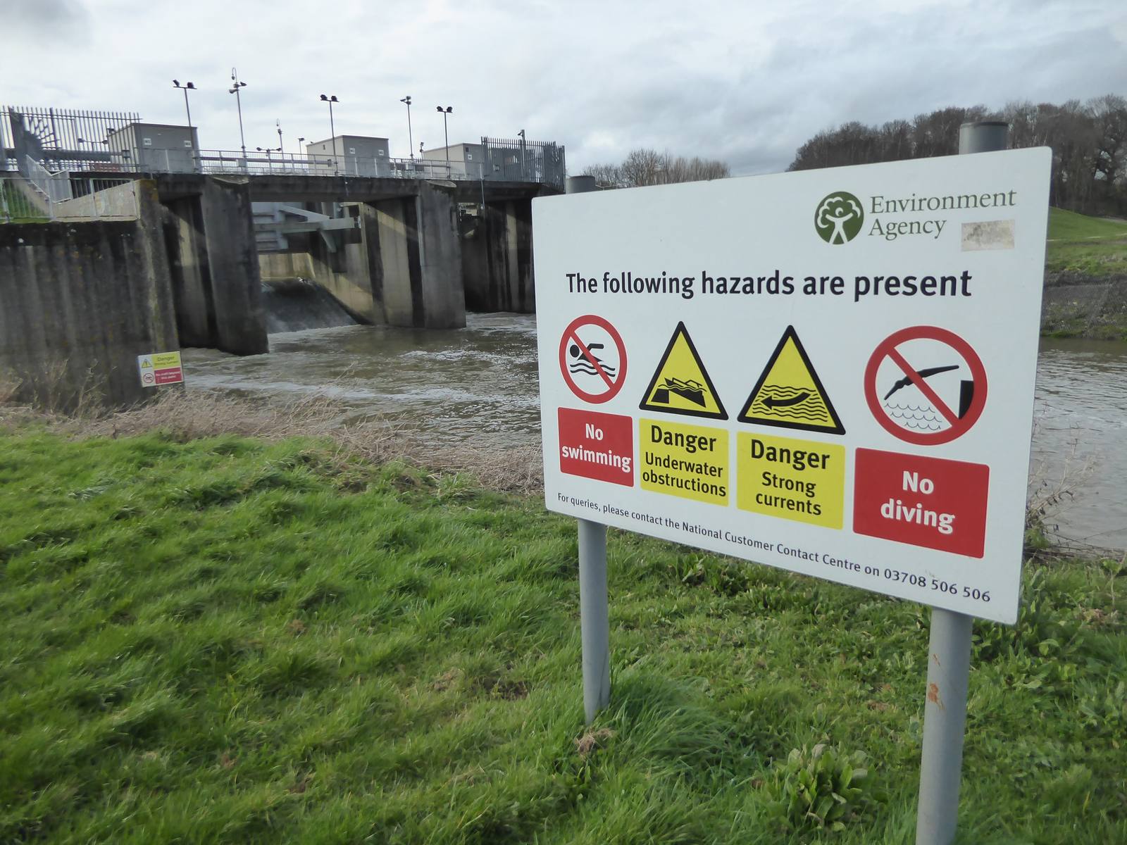 Environment Agency signage beside a flood defence structure