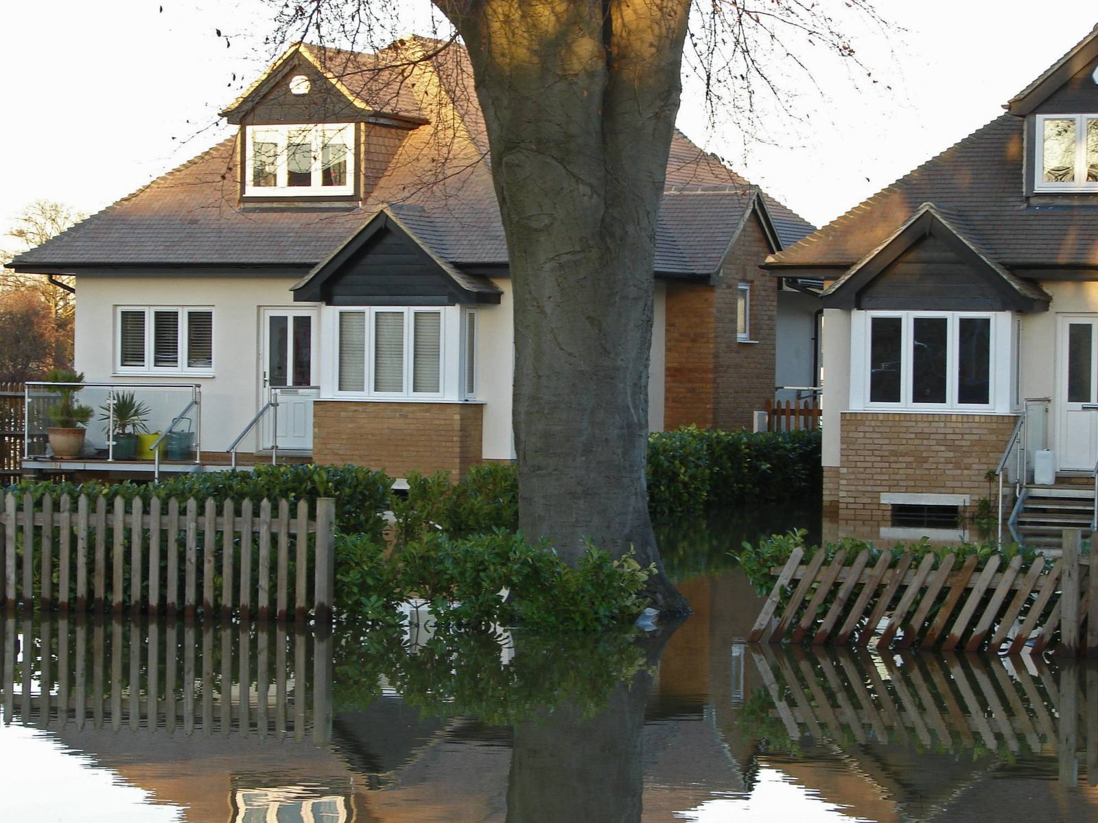 Flooded houses on a residential street in Chertsey, England