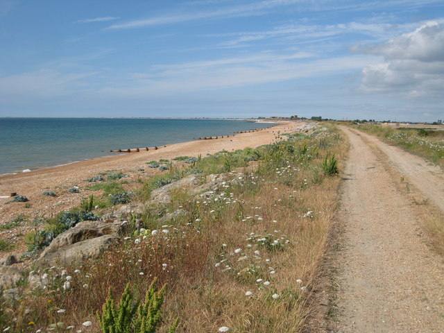 A shingle beach and coastal path at Hythe in Kent, looking along the shoreline