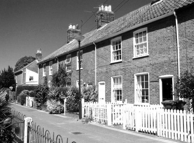 A terrace of 19th-century brick houses with picket fences